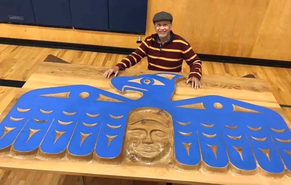 The Thunderbird Rises. Elder Latash Nahanee stands proudly beside his latest completed work