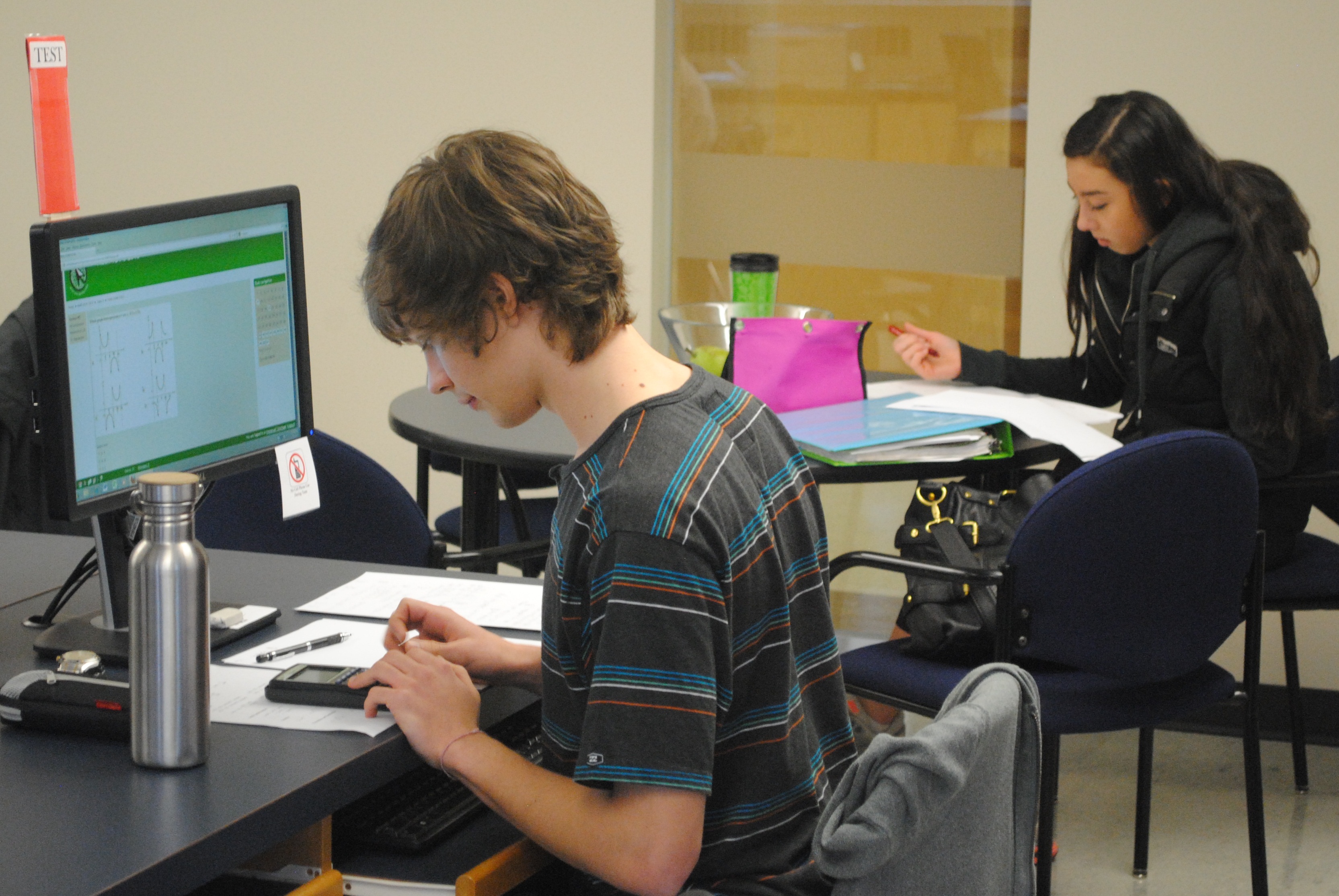 DL Two Students, one on computer, one on paper.jpg